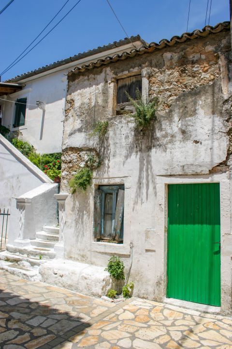 Lakones: A whitewashed house with a green door