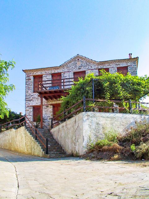 Agios Nikitas: An impressive, two-story mansion. It is stone-built and has wooden details.