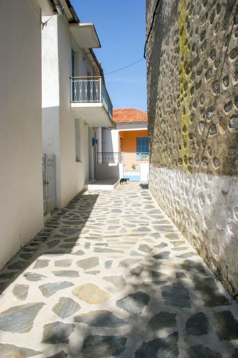 Trikeri: A paved alley with beautiful, traditional buildings.