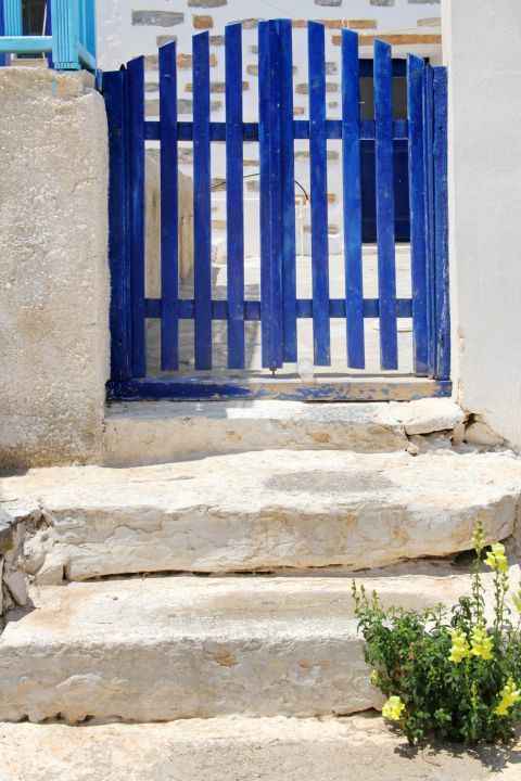Kamari: A blue-colored entrance of a white house