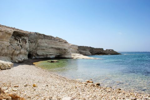 Psathi: A pebbled beach and rocky cliffs