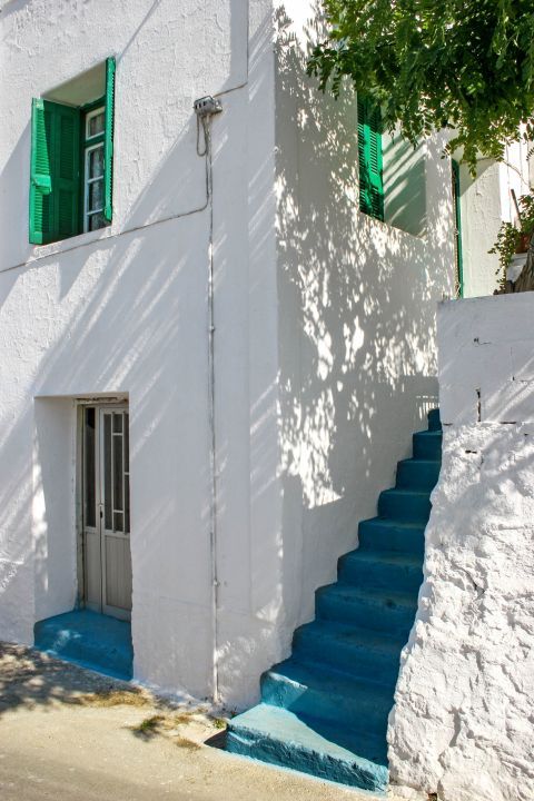 Kritinia: A whitewashed building with light blue and green details