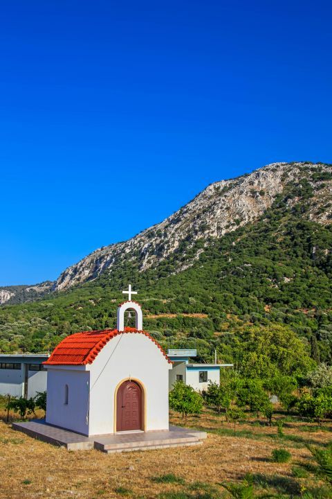 Salakos: A small chapel, surrounded by hills.
