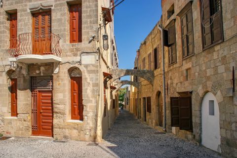 Town: Stone built buildings with wooden doors and shutters.
