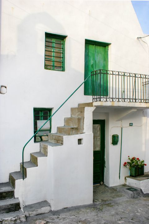 Town: A whitewashed house with green-colored shutters and doors.