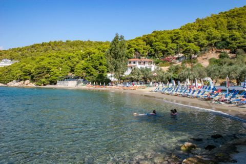 Monastiri: The beach has crystal clear waters and it is surrounded by lush vegetation.