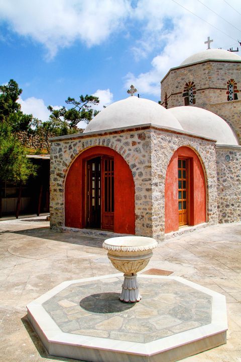 Pyrgos: A stone-built church with red-colored details