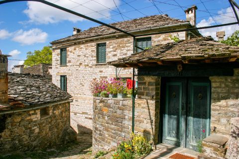 Mikro Papigo: Traditional houses with turquoise shutters and doors in Mikro Papigo village.