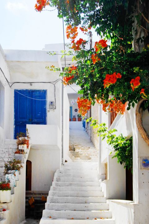 Apollonas: A whitewashed house with a blue colored door