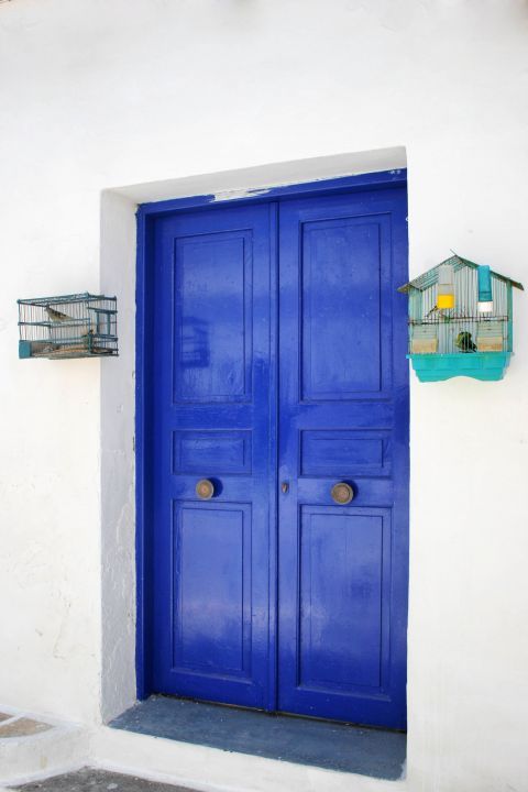 Chora: The blue-colored door of a lovely, whitewashed house in Chora,