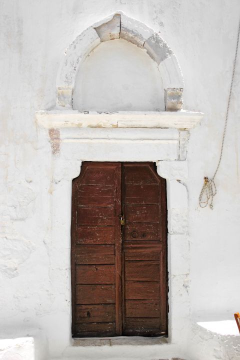 Chora: An old building with a heavy, wooden door.