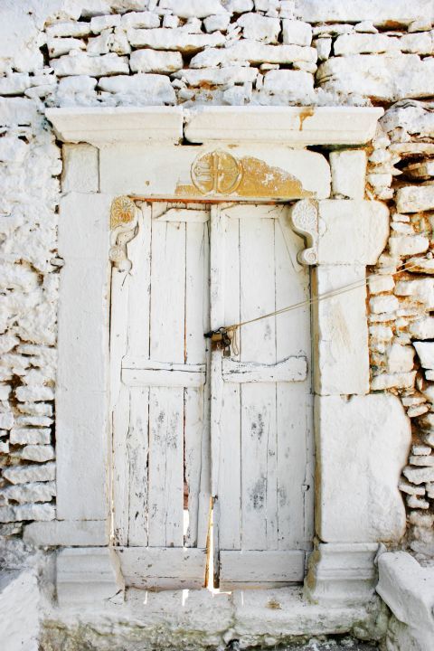 Chora: An old, wooden door of a local chapel.