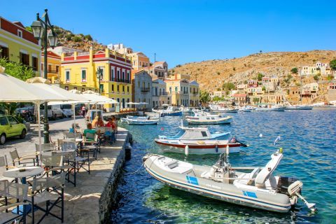 Town: Small boats and cafes by the sea. Symi Town.
