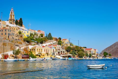 Town: View of the small harbor and vintage mansions in Symi.
