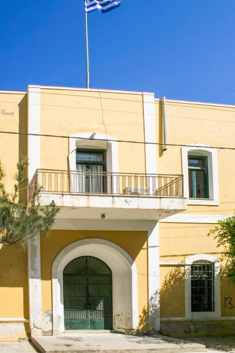 Ierapetra: A two-storey building, painted in yellow and green colors.