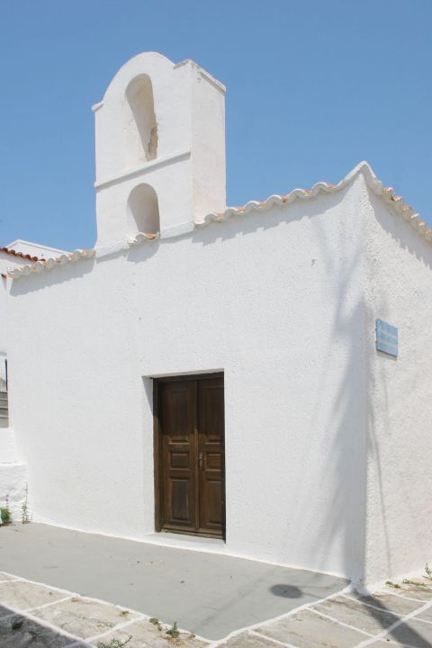 Chora: A whitewashed chapel with a wooden door.