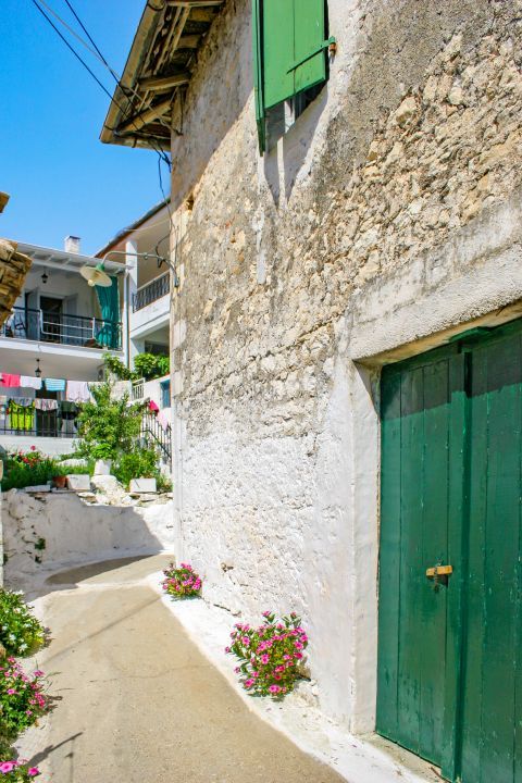 Spartochori: An old, stone built house with green colored shutters.
