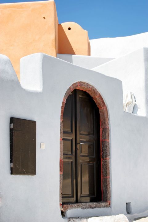 Finikia: A whitewashed building with a wooden door