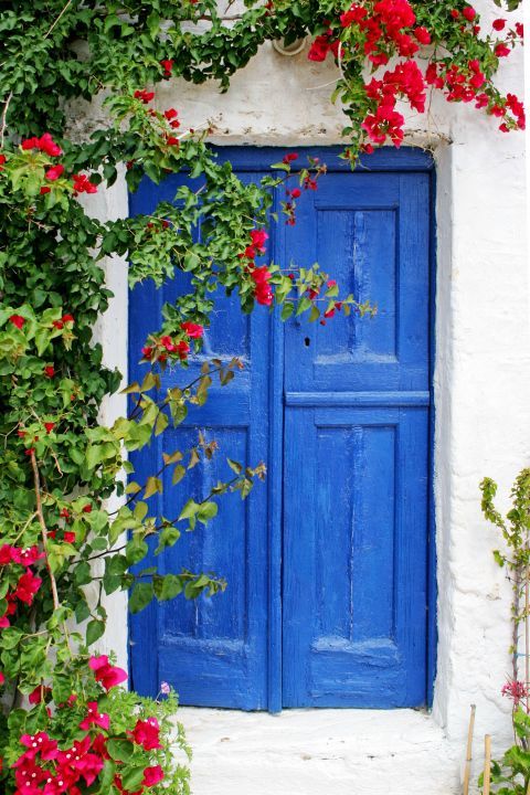 Sangri: A blue-colored door and beautiful flowers
