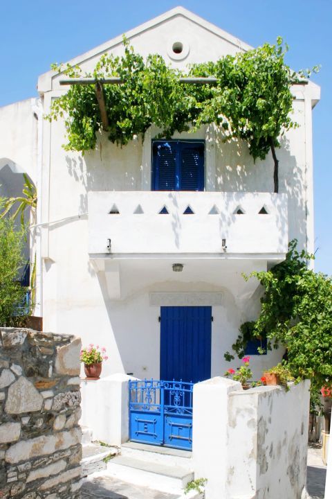 Potamia: A whitewashed building with blue colored details