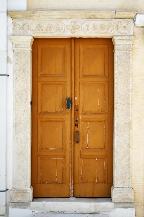 Chora: A wooden door. Chora, Andros.