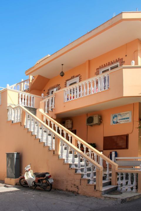 Afandou Village: An elegant building in pale orange and white colors.