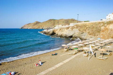 Panormos: Sandy beach with blue waters.