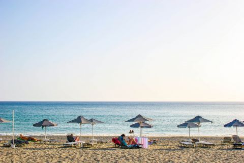 Plakias Beach: Umbrellas and sun loungers on the beachfront of Plakias beach.